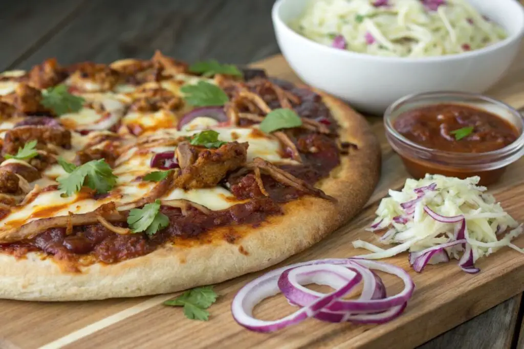 Pulled Pork BBQ Pizza combines tender, smoky pulled pork with tangy barbecue sauce, melty cheese, and a crispy crust. This sweet and savory pizza is perfect for barbecue lovers and a great way to use leftover pulled pork.